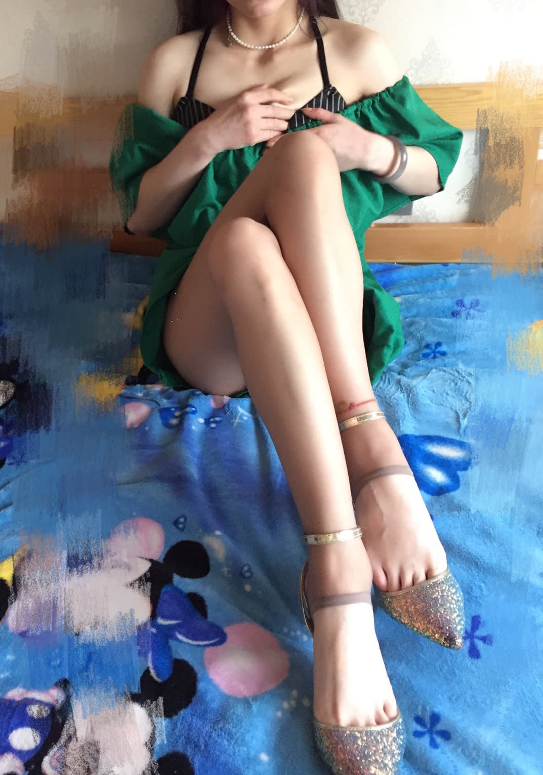 Close-up of stirrup pantyhose with open heel, showing nylon hugging calves and bare toes poised above a soft surface.